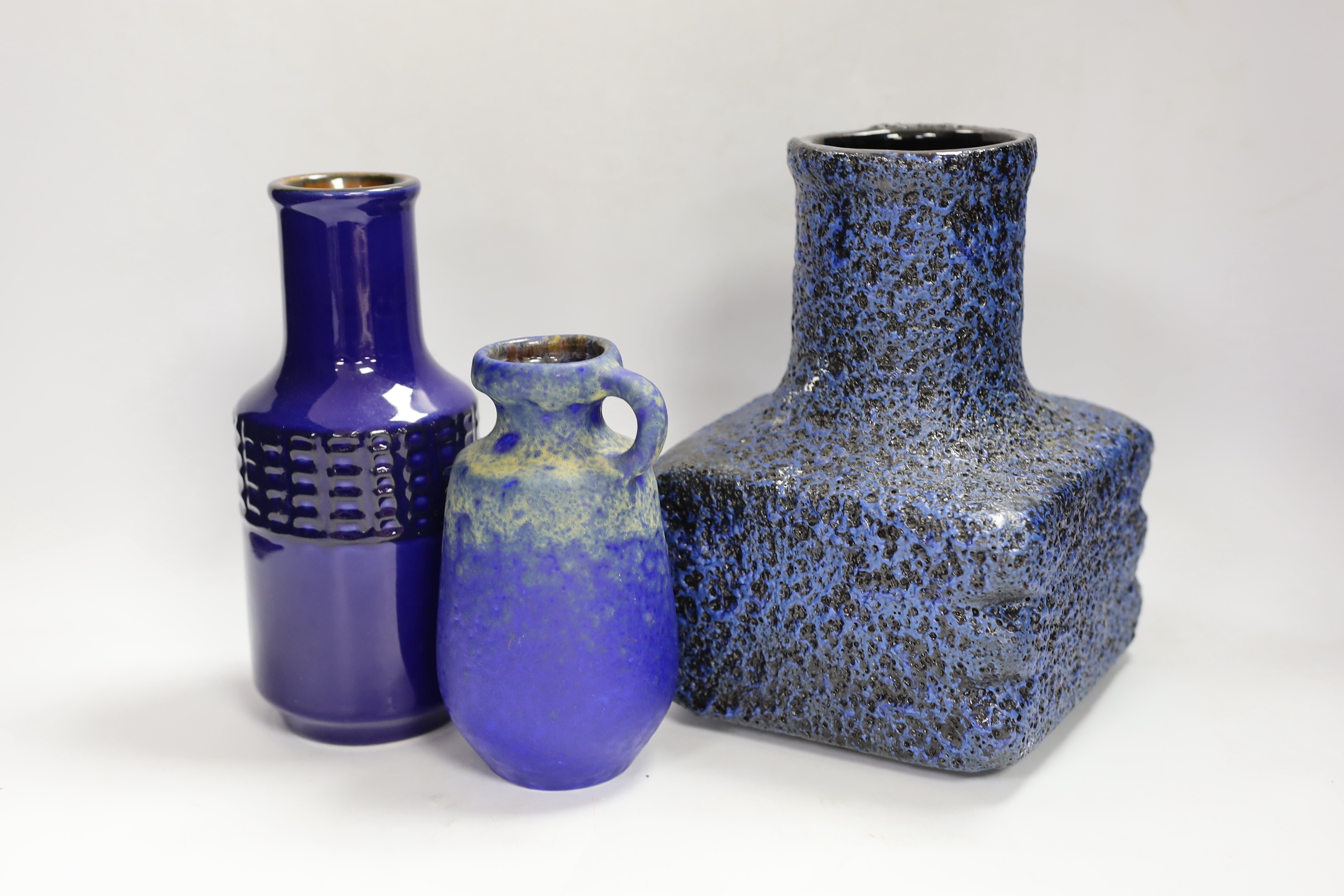 Three West German pottery vases in blue ground, one with lava glaze, tallest 22cm